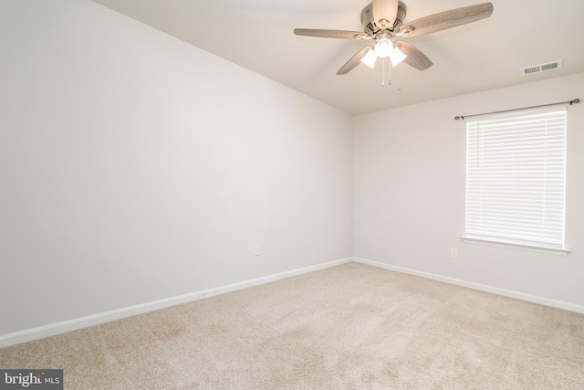 empty room featuring light colored carpet and ceiling fan