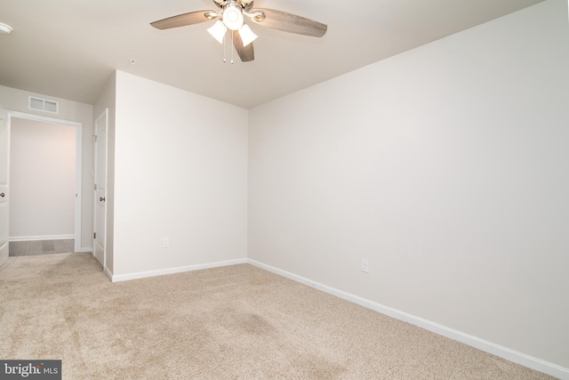 carpeted empty room featuring ceiling fan