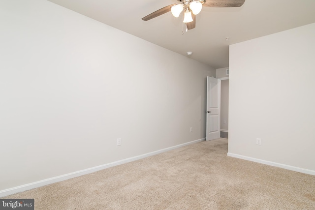 carpeted spare room with ceiling fan