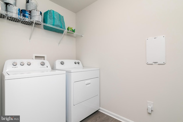 laundry area with separate washer and dryer and dark hardwood / wood-style flooring