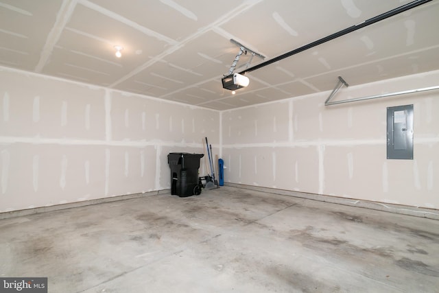 garage with a garage door opener and electric panel