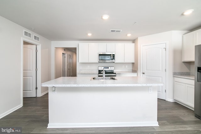 kitchen with sink, white cabinetry, a center island with sink, dark hardwood / wood-style flooring, and appliances with stainless steel finishes