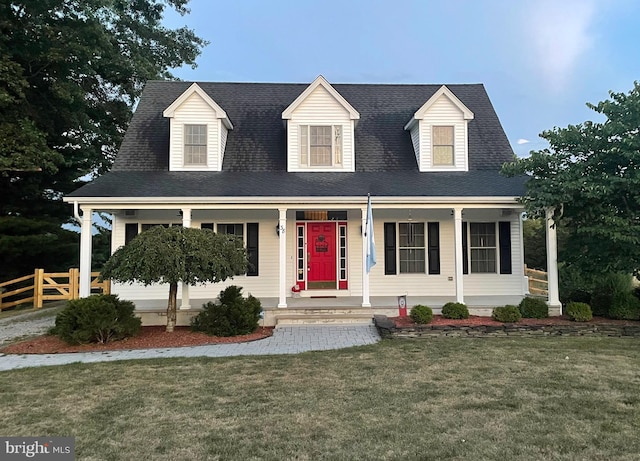 cape cod-style house with covered porch and a front lawn