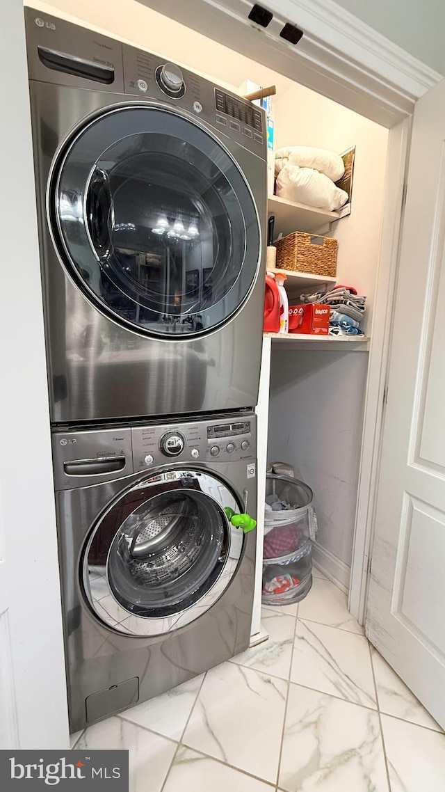 laundry room with stacked washing maching and dryer