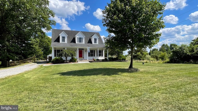 new england style home with a porch and a front lawn