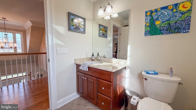 bathroom with toilet, tile patterned floors, ornamental molding, and a notable chandelier