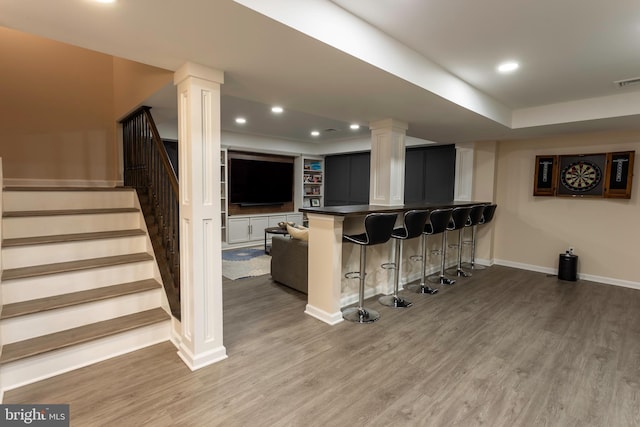 interior space featuring white cabinets and hardwood / wood-style floors