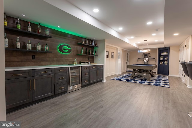 bar featuring billiards, beverage cooler, light hardwood / wood-style floors, and pendant lighting