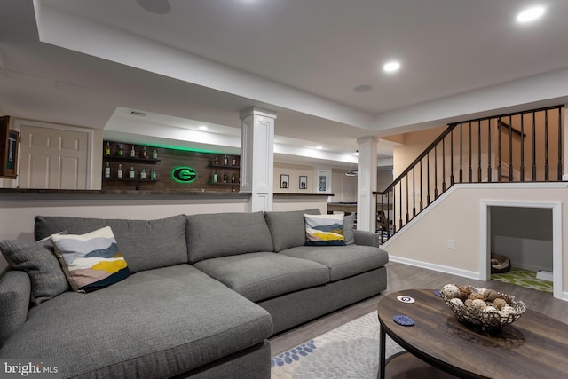 living room featuring hardwood / wood-style flooring and decorative columns