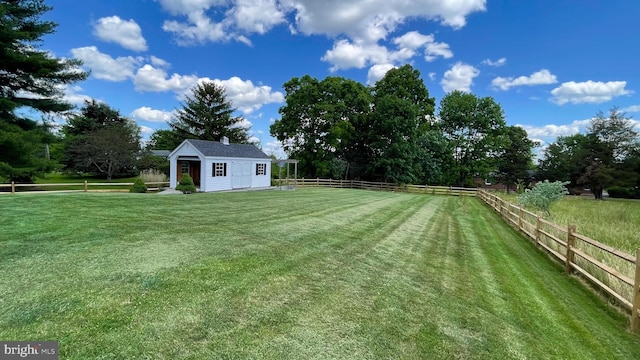 view of yard featuring a rural view and an outdoor structure