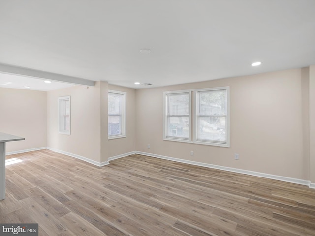 empty room with light hardwood / wood-style flooring