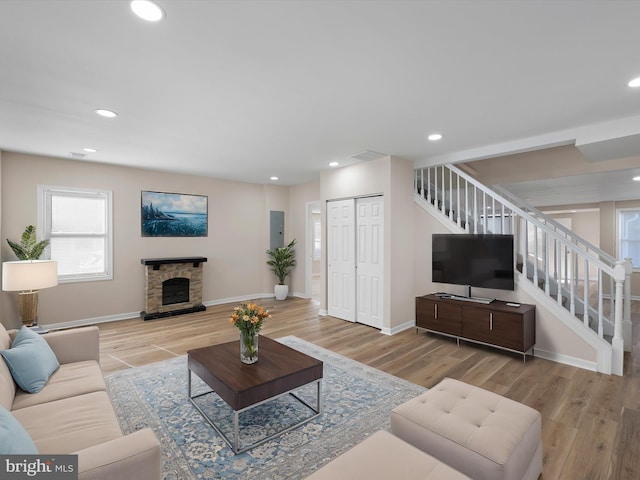 living room with a fireplace and light hardwood / wood-style flooring