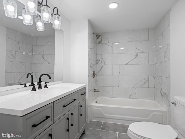 full bathroom featuring tile patterned floors, vanity, tiled shower / bath combo, and toilet