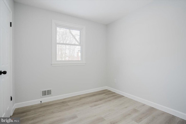 empty room with light hardwood / wood-style floors