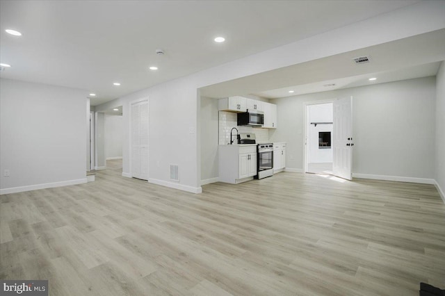 unfurnished living room with light wood-type flooring