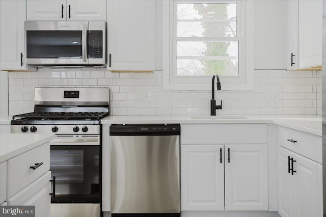 kitchen with sink, white cabinetry, and stainless steel appliances