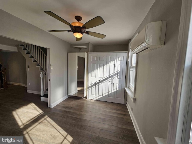 foyer entrance with ceiling fan, a wall mounted AC, and dark hardwood / wood-style floors