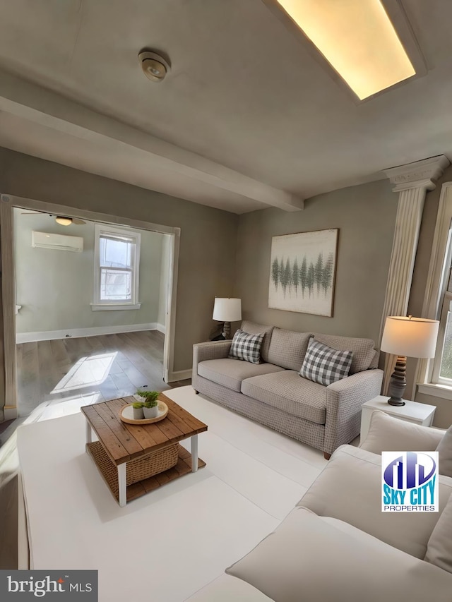 living room featuring a wall mounted AC and light hardwood / wood-style floors