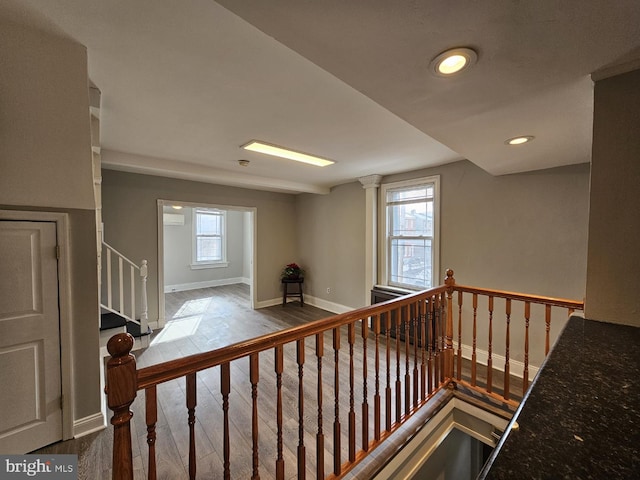 stairway featuring hardwood / wood-style floors and a healthy amount of sunlight