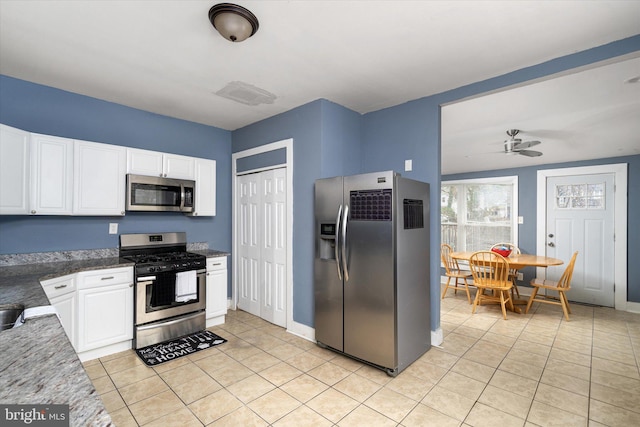 kitchen with ceiling fan, light tile patterned flooring, white cabinets, and appliances with stainless steel finishes