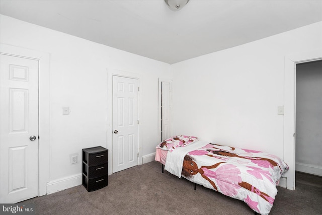 bedroom featuring dark carpet