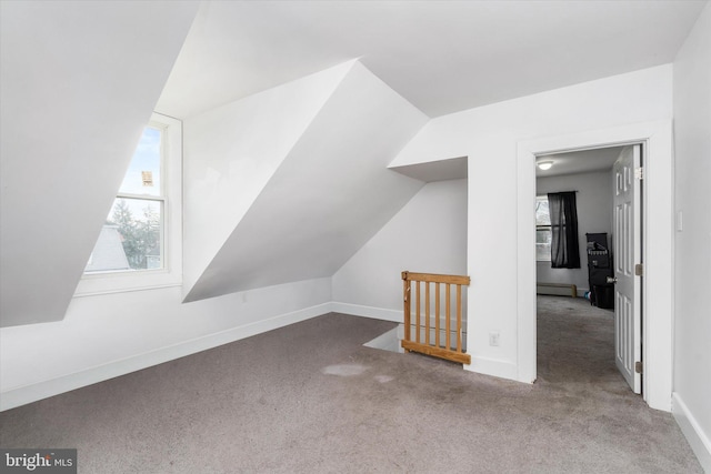 bonus room featuring lofted ceiling, carpet, and a baseboard heating unit