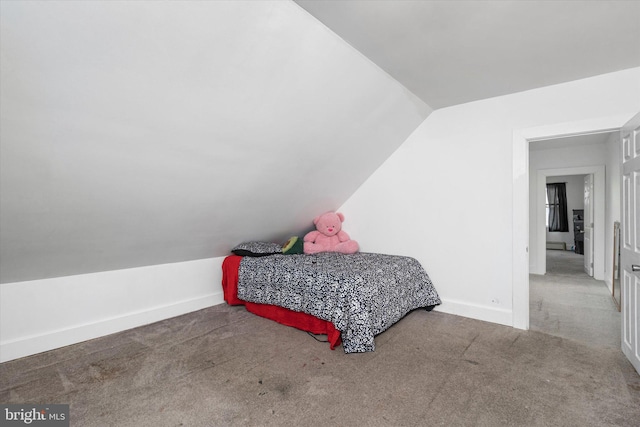 bedroom with lofted ceiling and carpet floors