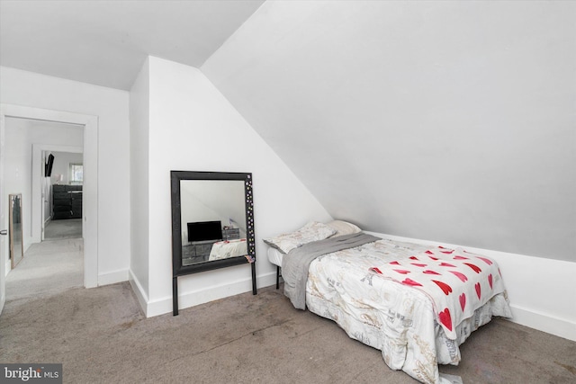 bedroom with carpet floors and vaulted ceiling