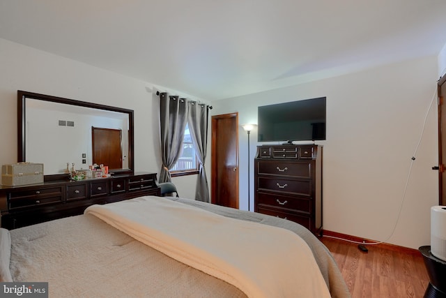 bedroom with hardwood / wood-style floors