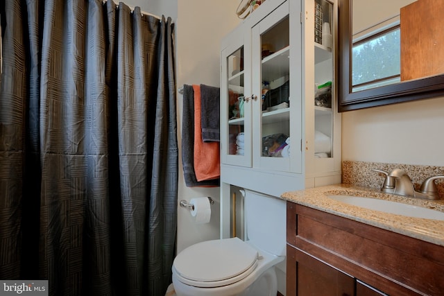 bathroom featuring toilet and vanity