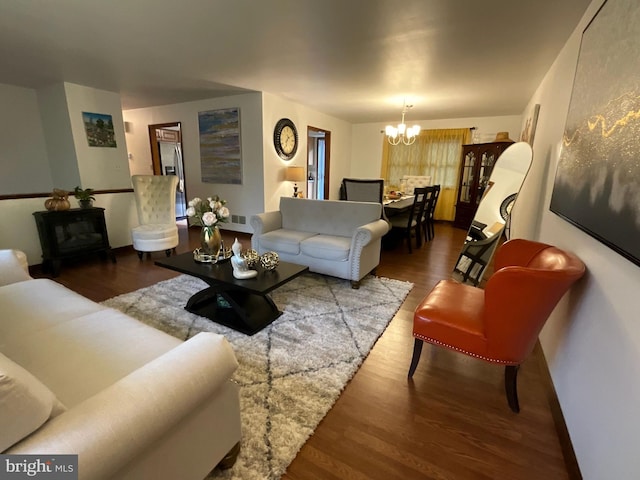 living room featuring dark hardwood / wood-style flooring and a notable chandelier