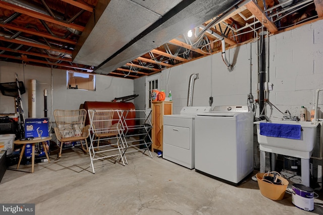 basement featuring washing machine and dryer and sink