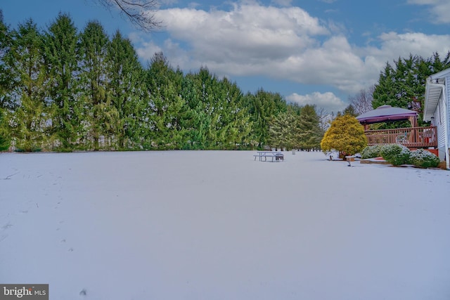 yard layered in snow with a gazebo