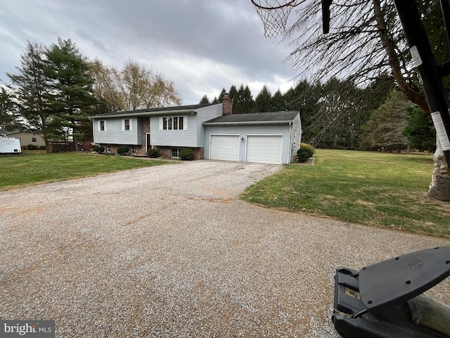 raised ranch with a front lawn and a garage