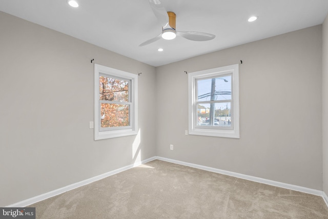 unfurnished room featuring ceiling fan and light colored carpet