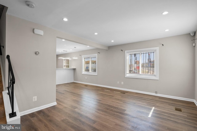 unfurnished living room featuring dark hardwood / wood-style floors