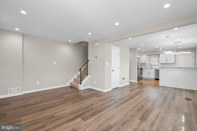 unfurnished living room with hardwood / wood-style floors