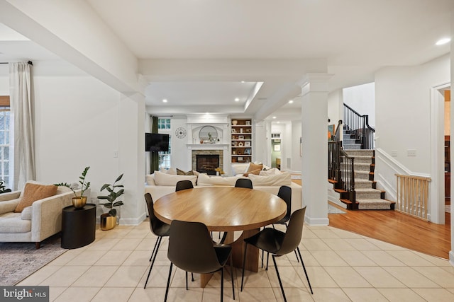 dining room featuring light tile patterned flooring and ornate columns