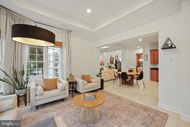 tiled living room featuring ornate columns