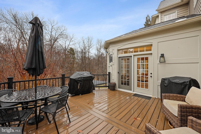 wooden terrace with a grill