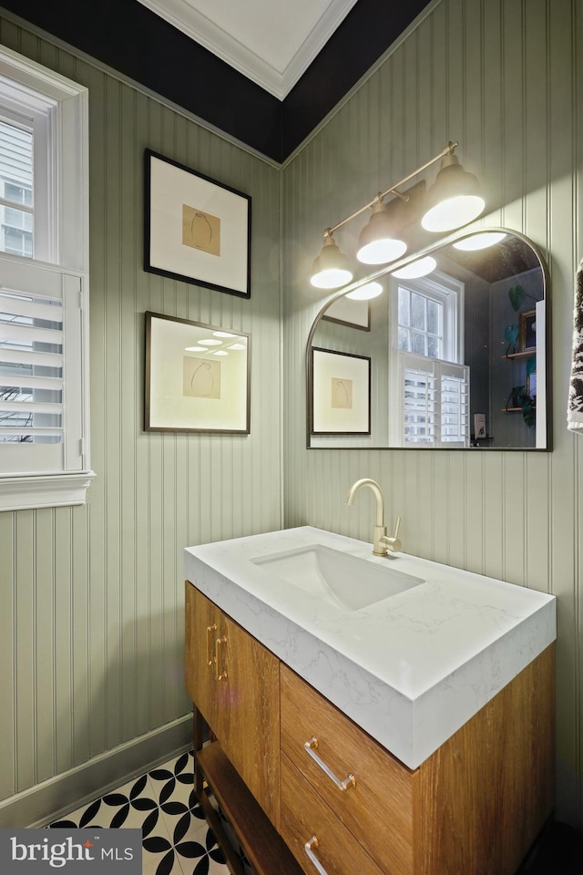 bathroom featuring ornamental molding and vanity