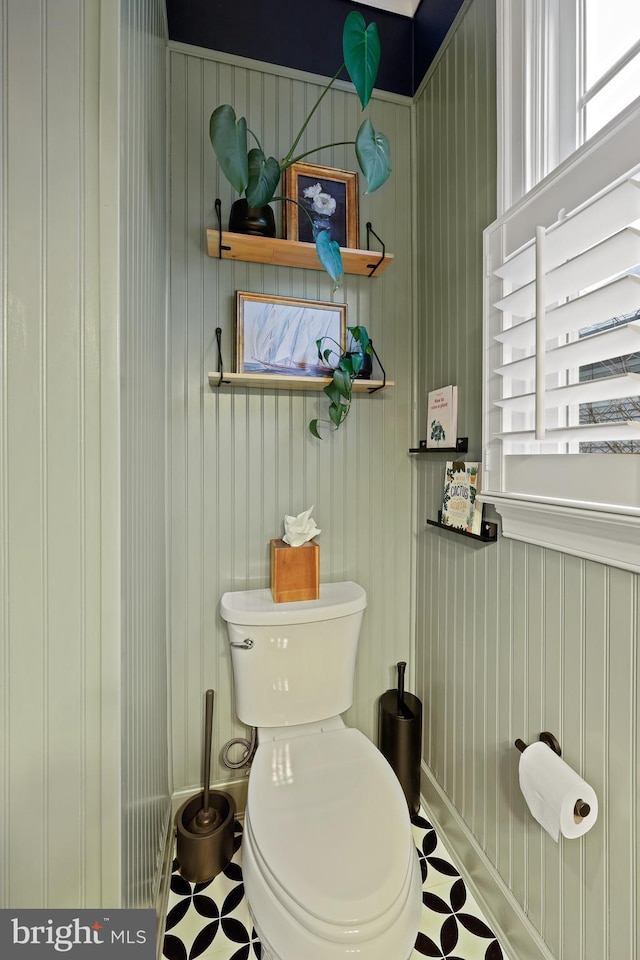 bathroom featuring a wealth of natural light and toilet