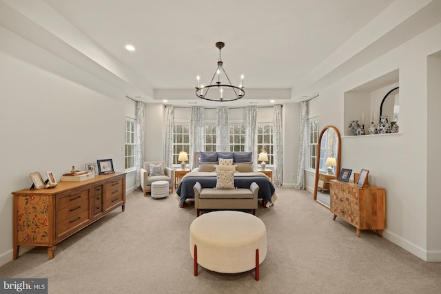 bedroom featuring light colored carpet and a chandelier