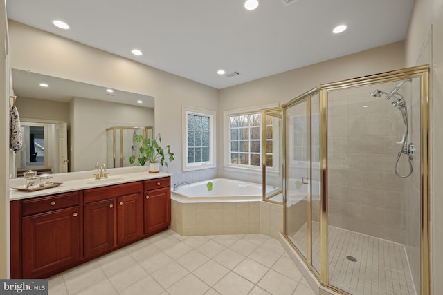 bathroom with vanity, tile patterned floors, and plus walk in shower