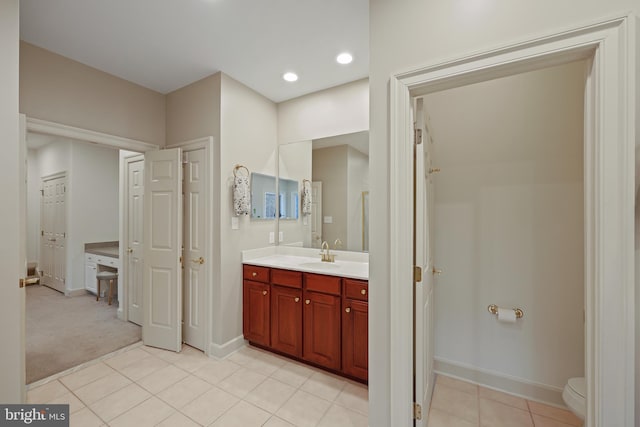 bathroom with vanity, toilet, and tile patterned flooring