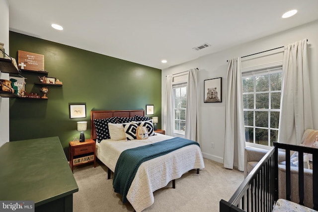 bedroom featuring light carpet