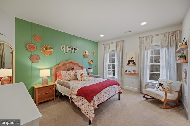 carpeted bedroom with multiple windows