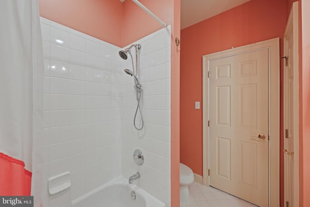 bathroom featuring tile patterned floors, toilet, and shower / bath combo with shower curtain