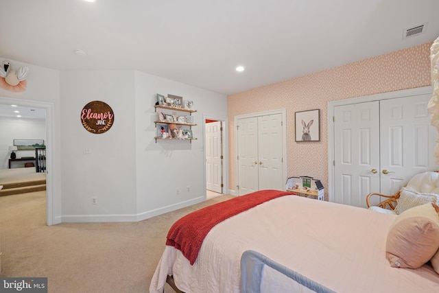 carpeted bedroom with two closets