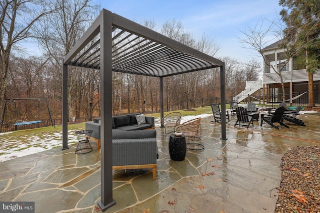 view of patio featuring a trampoline, an outdoor living space, and a pergola